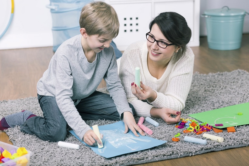 mom and child drawing with chalk