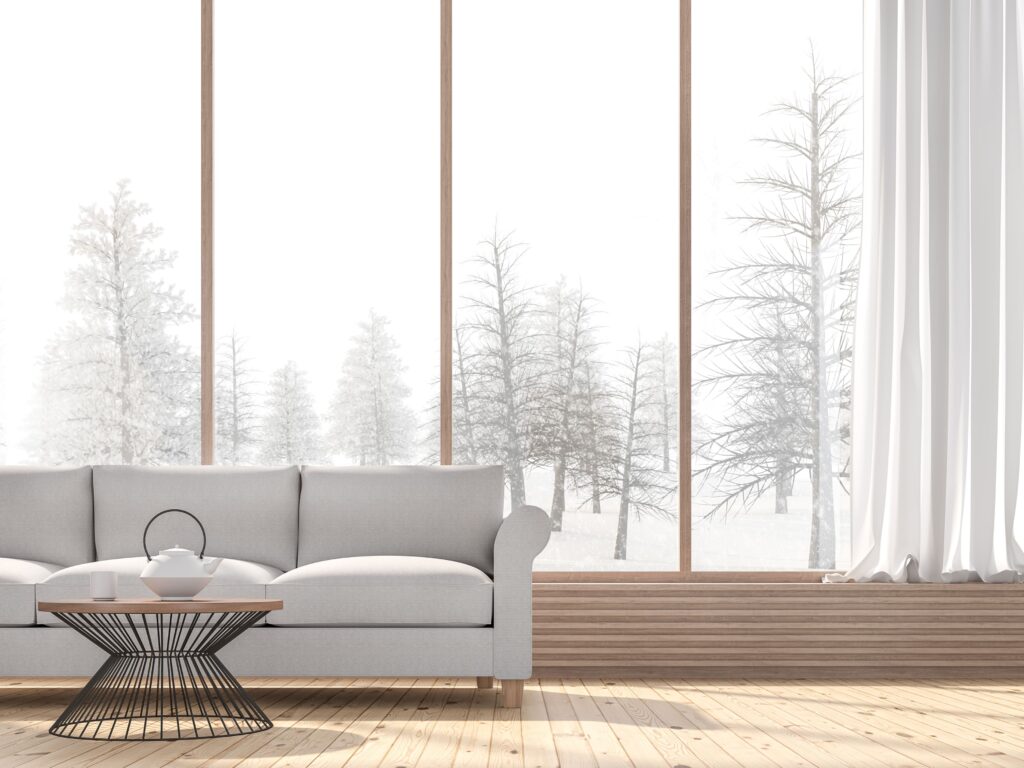 living room with hardwood flooring and window with snow falling outside