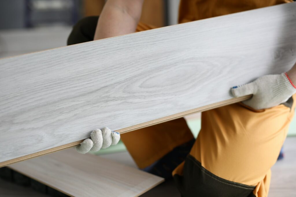 person holding floor panel