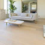 Light wood floors with cream couch and coffee table