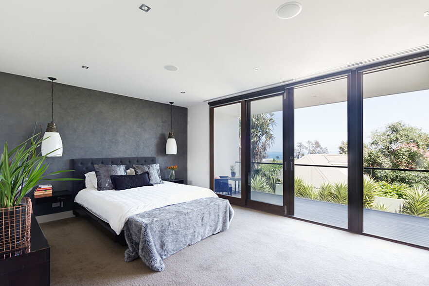 light carpet in bedroom with large windows