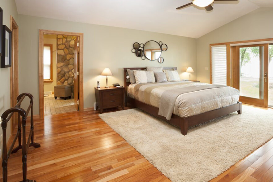 hardwood floors in bedroom with rug