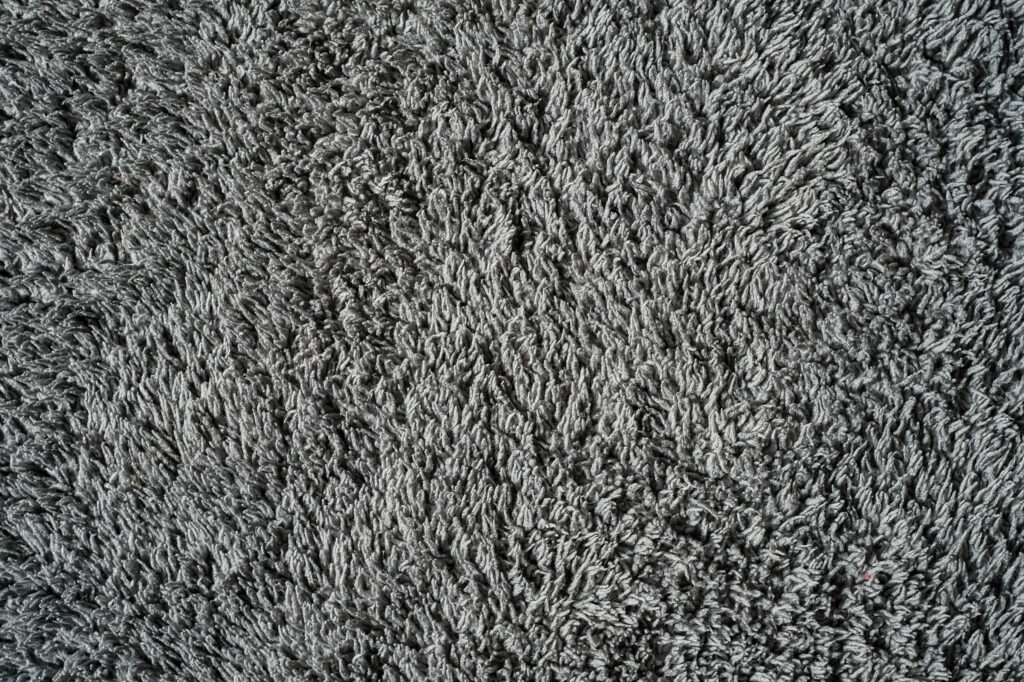 Gray background from microfiber fabric, idea for wallpaper or screen about materials. Synthetic matter