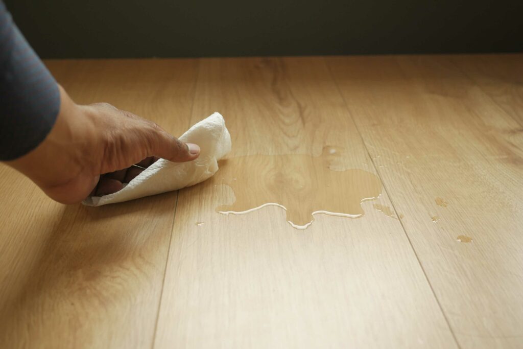 man removing the water from laminate floor