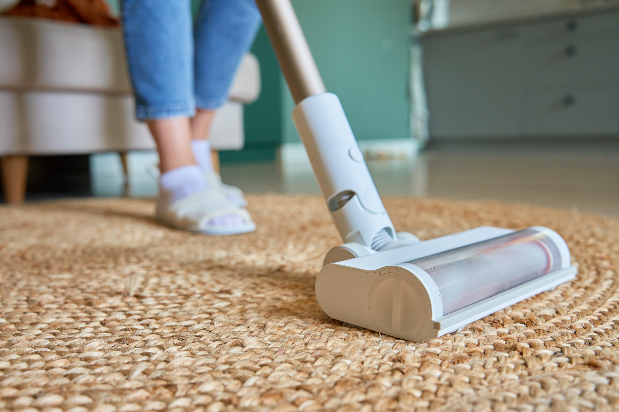 Close up of vacuum cleaner brush cleaning carpet on floor